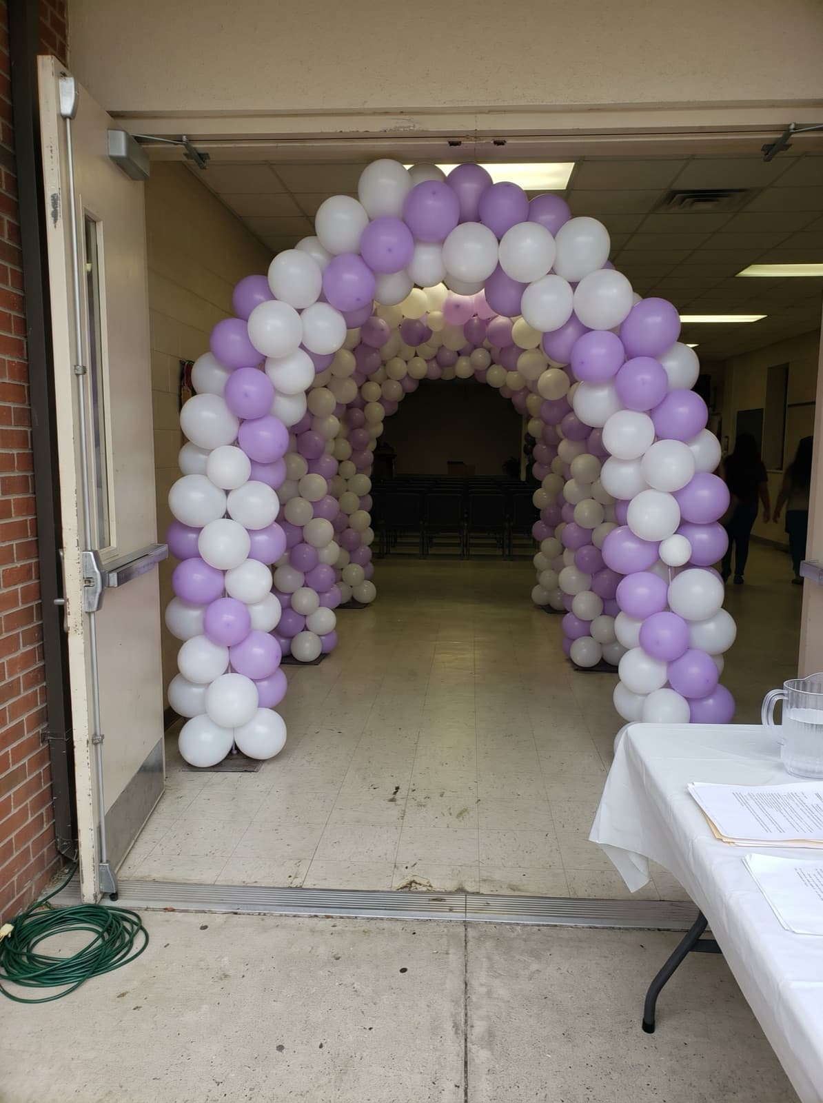 Balloon tunnel of linked arches at an event hall entrance