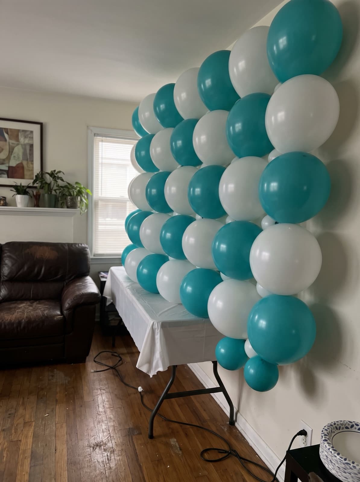 Grid balloon wall in a teal and white checkerboard